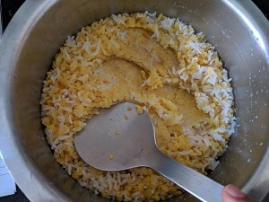 Mashing the rice and dal for soft pongal