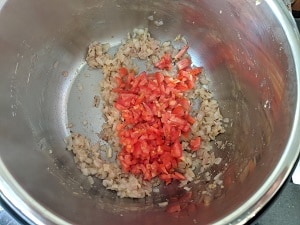 sauteing onion, tomato, ginger garlic paste with cumin seeds for lauki chana dal sabzi