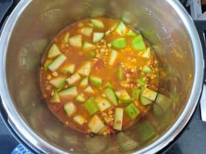 water, lentils and lauki added to instant pot for pressure cooking