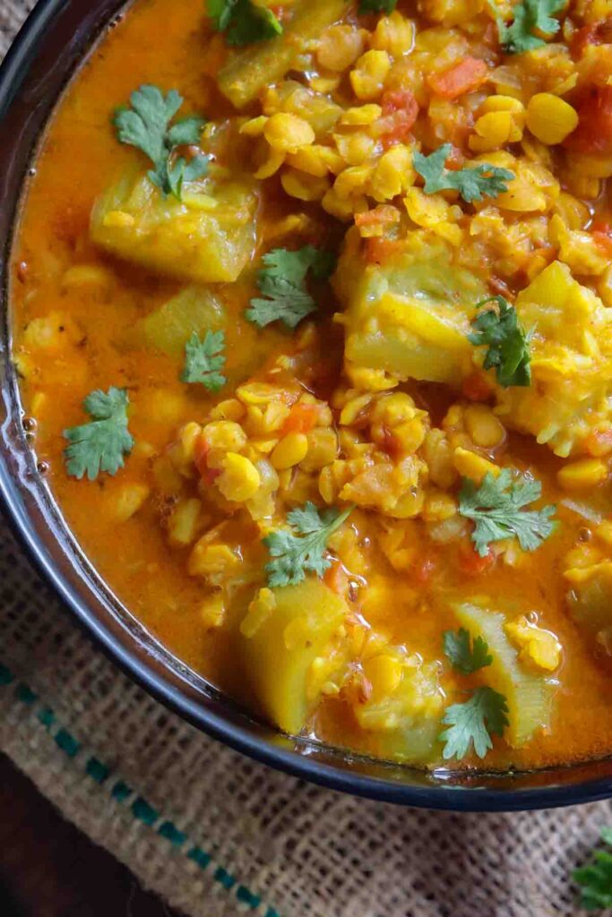 close up image of vegan curry with calabash and lentils