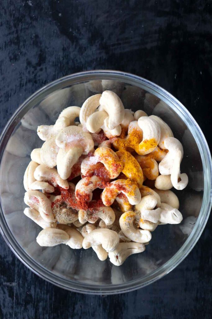 a bowl of raw cashew nuts with indian spices and salt