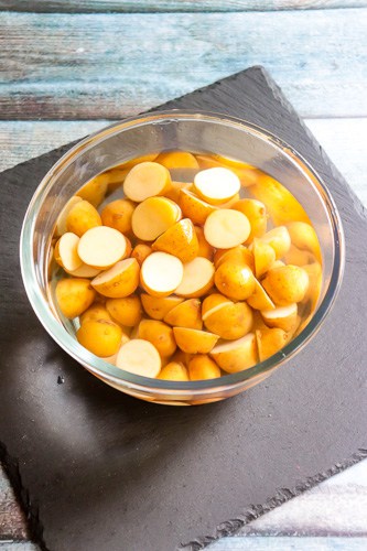 Baby potatoes cut and soaked in water