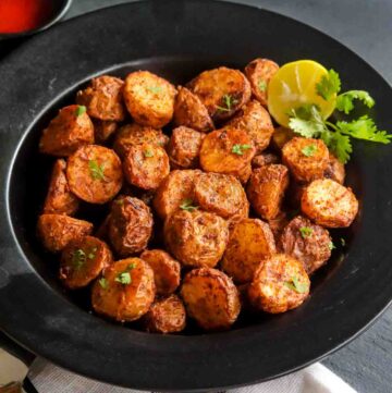 Air Fryer Roasted potatoes served with lime wedge