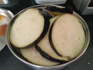 Eggplants sliced and soaked in water to avoid discolouration