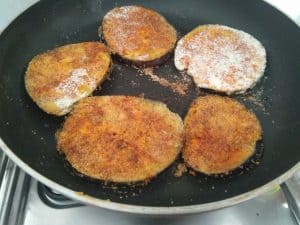 Eggplants shallow frying in the pan