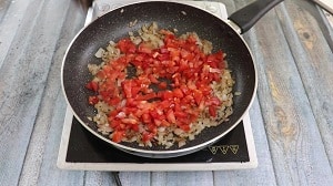 chopped tomatoes added to the browned onions