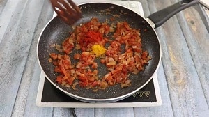 kashmiri red chilli and turmeric added to the onion-tomato base