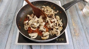 sauteeing the mushrooms with the onion-tomato gravy