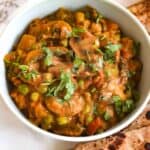 Close up view of Mushroom Masala with peas garnished with coriander