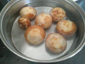 Urad dal vadas soaked in water for dahi vada