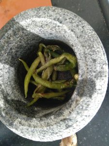 Salt and Green chillies to be pounded in mortar and pestle