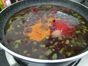 Turmeric red chilli powder and salt added to the Puli inji
