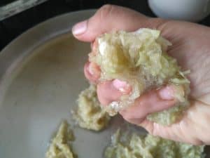 Squeeze out excess moisture from the lauki