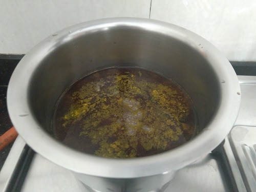 Tamarind simmering with turmeric powder and salt