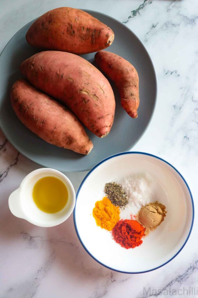 Ingredients for making sweet potato fries in air fryer - sweet potatoes, spices and olive oil