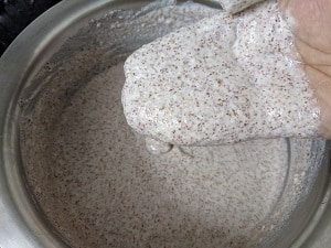 Mix the Ragi Idli Batter with your hand for 5 minutes for effective fermentation