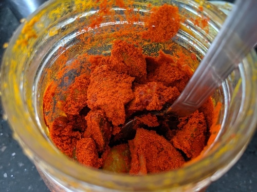 Adding red chilli powder to Narthangai