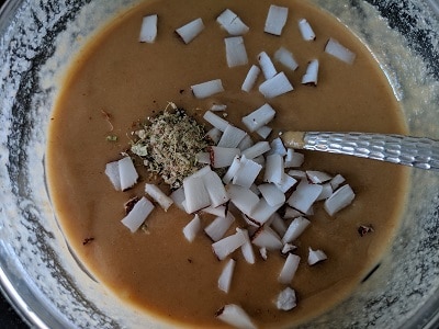 Adding coconut and cardamom