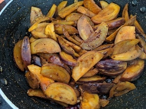 Brinjal cooking with spices and tempering