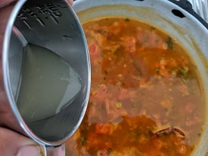 Adding lemon juice to Rasam
