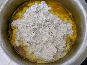 Adding the coconut gravy to cooked mangoes
