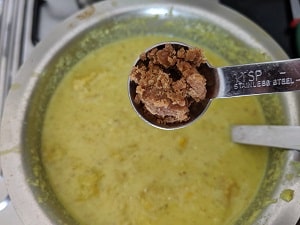 Adding jaggery to pulissery