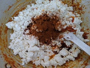 Adding the paneer to the onion tomato mix with garam masala