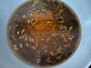 Turmeric powder, hing added to the tamarind extract and vazhaipoo