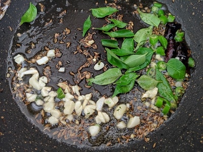 Curry Leaves and garlic added to the tempering