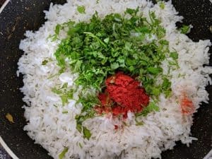 Cooked Rice with red chilli powder and coriander leaves