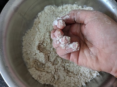 Adding water to make the chakli dough