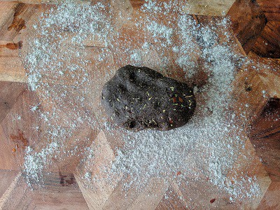 Dust some flour on the wooden surface and roll out the dough