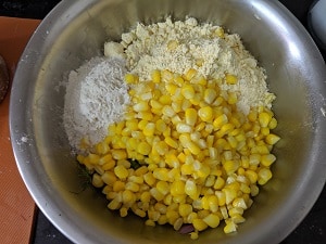 Steamed corn is added
