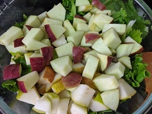 Chopped pears and apples added to the lettuce leaves