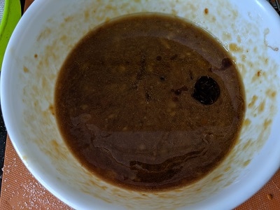 Vanilla Essence, coconut milk and oil added to the mashed banana and jaggery mix