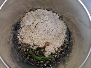 Adding Gram Flour to the Moong sprouts with green chilli and ginger paste