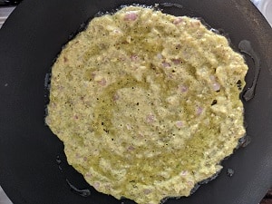 Chilla cooking on a hot griddle