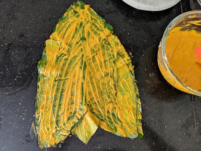 place one leaf above the other (upside down) and keep applying the besan batter on each alu leaf