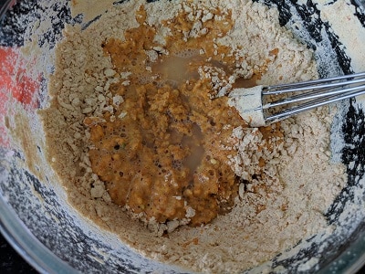 adding water for a thick consistency besan batter for alu vadi recipe