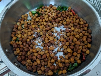 add the cooked chickpeas to the tempering with salt to taste