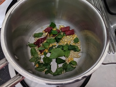 Tempering for the kootu - Coconut oil, mustard seeds, urad dal, chana dal, whole red chillies and curry leaves