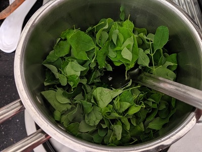 Add the washed drumstick leaves to the tempering