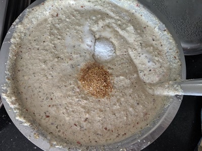 Adding salt and hing or asafoetida to the batter