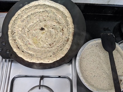 Making the dosa on the hot griddle