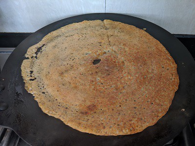 Dosa to be flipped and cooked on the other side.