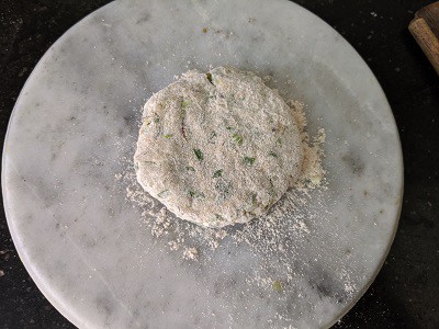 Dust the dough balls with flour to roll the paratha easily