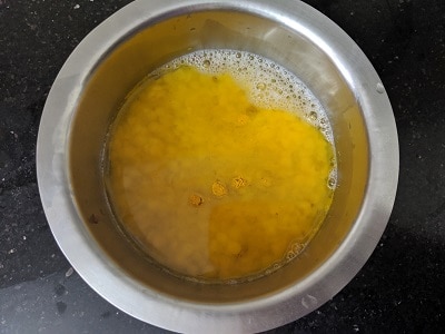 Toor Dal soaked and to be pressure cooked with turmeric powder