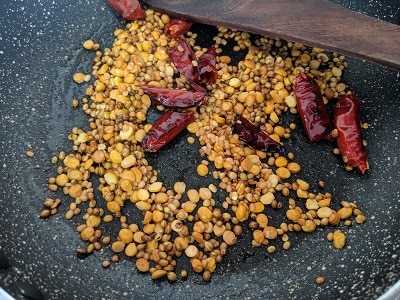 Roasting the lentils until brown and the chillies until they are crisp