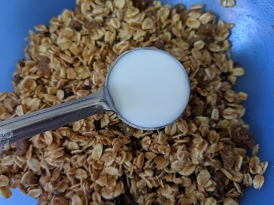 Adding milk to bind the ingredients for cookies