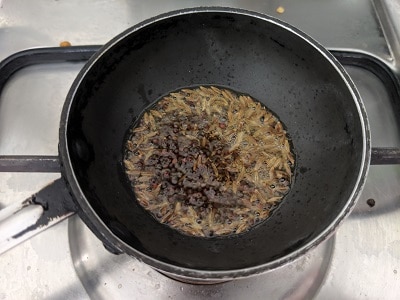 Tempering for pudina rasam - ghee, mustard seeds, jeera and curry leaves with a pinch of asafoetida